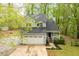 Aerial view of a two-story home with a large driveway, mature trees and landscaping at 120 Kerigon Ln, Youngsville, NC 27596