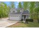 Charming two-story home with a well-maintained front yard, large garage, and inviting front porch at 120 Kerigon Ln, Youngsville, NC 27596