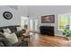 Bright living room with hardwood floors, comfortable seating, and view to dining area at 120 Kerigon Ln, Youngsville, NC 27596