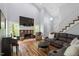 Bright living room with high ceilings, stone fireplace, and comfortable seating at 120 Kerigon Ln, Youngsville, NC 27596