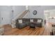 Spacious living room showcasing hardwood floors, staircase, and comfortable sofa at 120 Kerigon Ln, Youngsville, NC 27596