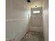 Bathroom with tub, unfinished walls, and a window, awaiting personalization and finishing touches at 125 Tee Dr, Selma, NC 27576