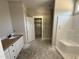 A bathroom featuring a white vanity, shower and toilet at 125 Tee Dr, Selma, NC 27576