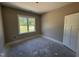 Bedroom featuring carpeted floors, natural light, a window and a closet door at 125 Tee Dr, Selma, NC 27576