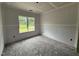 Bedroom with a large window, unfinished walls, creating a canvas for customization at 125 Tee Dr, Selma, NC 27576