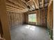 Unfinished bedroom with a window provides natural light, highlighting the space's construction phase at 125 Tee Dr, Selma, NC 27576