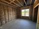 New bedroom construction: a window in a frame providing natural light to the unfinished space at 125 Tee Dr, Selma, NC 27576