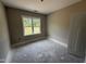 Bedroom with a large window, base molding, and fresh paint at 125 Tee Dr, Selma, NC 27576