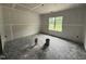 Bedroom with unfinished walls and ceiling, and a window bringing natural light into the spacious room at 125 Tee Dr, Selma, NC 27576