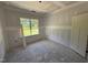 Unfinished bedroom with a large window at 125 Tee Dr, Selma, NC 27576