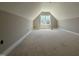 Unfinished bonus room featuring natural light from a window and neutral walls at 125 Tee Dr, Selma, NC 27576