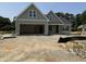 New construction home featuring an attached two car garage and lovely, light green exterior paint at 125 Tee Dr, Selma, NC 27576