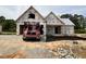New home construction featuring a two car garage with a red truck parked in the driveway at 125 Tee Dr, Selma, NC 27576