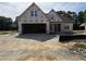 New construction home featuring a two-car garage and partially completed front entrance at 125 Tee Dr, Selma, NC 27576