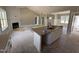 Open kitchen featuring an island with a sink and white cabinets, next to a living room with a fireplace at 125 Tee Dr, Selma, NC 27576