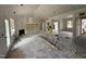 Bright living room with high ceilings, a fireplace, and a large window offering a view to the outside at 125 Tee Dr, Selma, NC 27576