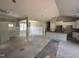 Spacious living room open to the kitchen featuring white wainscotting and lots of natural light at 125 Tee Dr, Selma, NC 27576