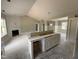 Open living area with fireplace and kitchen area with island cabinetry at 125 Tee Dr, Selma, NC 27576