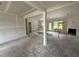Spacious living room featuring unfinished walls, door to the backyard, and a cozy fireplace under construction at 125 Tee Dr, Selma, NC 27576