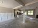 Spacious living room open to the kitchen featuring white wainscotting and lots of natural light at 125 Tee Dr, Selma, NC 27576