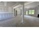 Unfinished living room with natural light and visible framing, offering a spacious open-concept design at 125 Tee Dr, Selma, NC 27576