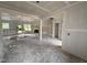 Open living room with large windows, unfinished walls, awaiting transformation into a welcoming space at 125 Tee Dr, Selma, NC 27576