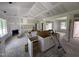 Open-concept living room features a fireplace, large windows, and rough-in kitchen cabinets at 125 Tee Dr, Selma, NC 27576