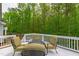 Outdoor deck area with comfortable seating surrounded by lush greenery for a peaceful retreat at 12833 Edsel Dr, Raleigh, NC 27613