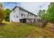 Spacious backyard with mature trees and wooden fence bordering the property at 12833 Edsel Dr, Raleigh, NC 27613