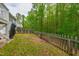 Lush backyard with a wooden fence, mature trees, and a serene natural setting at 12833 Edsel Dr, Raleigh, NC 27613