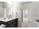 Well-maintained bathroom with a vanity, mirror and access to a hallway at 12833 Edsel Dr, Raleigh, NC 27613