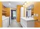 Contemporary bathroom with a modern vanity, storage, and access to a laundry area at 12833 Edsel Dr, Raleigh, NC 27613