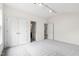 Well-lit bedroom with neutral carpet, bright walls and adjoining bathroom at 12833 Edsel Dr, Raleigh, NC 27613