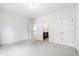 Bright bedroom features neutral carpet, bright walls, and ensuite bathroom at 12833 Edsel Dr, Raleigh, NC 27613
