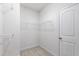 Walk-in closet featuring wire shelves and a door at 12833 Edsel Dr, Raleigh, NC 27613