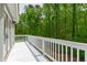 A wooden deck provides beautiful views of the surrounding greenery and natural landscape at 12833 Edsel Dr, Raleigh, NC 27613