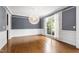 Formal dining room features hardwood floors, modern lighting, and neutral paint scheme at 12833 Edsel Dr, Raleigh, NC 27613