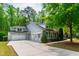Spacious home featuring a three-car garage, ample parking, and a professionally landscaped yard with mature trees at 12833 Edsel Dr, Raleigh, NC 27613