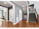 Spacious foyer with hardwood floors, staircase, closet, and grey walls at 12833 Edsel Dr, Raleigh, NC 27613