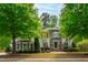 Charming two-story home features a stone and siding facade, lush landscaping, and a well-manicured lawn at 12833 Edsel Dr, Raleigh, NC 27613