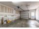 Spacious garage with unfinished walls, sink, and garage door ready to be used at 12833 Edsel Dr, Raleigh, NC 27613