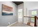 Hallway with artwork on the grey walls and white trim around the doorway at 12833 Edsel Dr, Raleigh, NC 27613