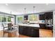 Bright kitchen features a large island, stainless steel appliances, hardwood floors and views to the deck at 12833 Edsel Dr, Raleigh, NC 27613
