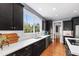 Updated kitchen featuring stainless steel appliances and stylish black cabinetry at 12833 Edsel Dr, Raleigh, NC 27613
