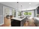 Open kitchen view to living and dining areas, features island with cooktop at 12833 Edsel Dr, Raleigh, NC 27613