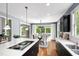 Open kitchen view to dining area, features island with cooktop and ample cabinetry at 12833 Edsel Dr, Raleigh, NC 27613