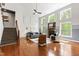 Bright living room featuring high ceilings, a stone fireplace, hardwood floors, and large windows with scenic views at 12833 Edsel Dr, Raleigh, NC 27613