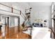 Spacious living room with hardwood floors, staircase, and abundant natural light at 12833 Edsel Dr, Raleigh, NC 27613