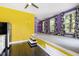 A living room with a raised platform floor, large windows, and colorful curtains at 12833 Edsel Dr, Raleigh, NC 27613