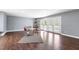 Open living room with hardwood floors and natural light flowing through the French doors at 12833 Edsel Dr, Raleigh, NC 27613